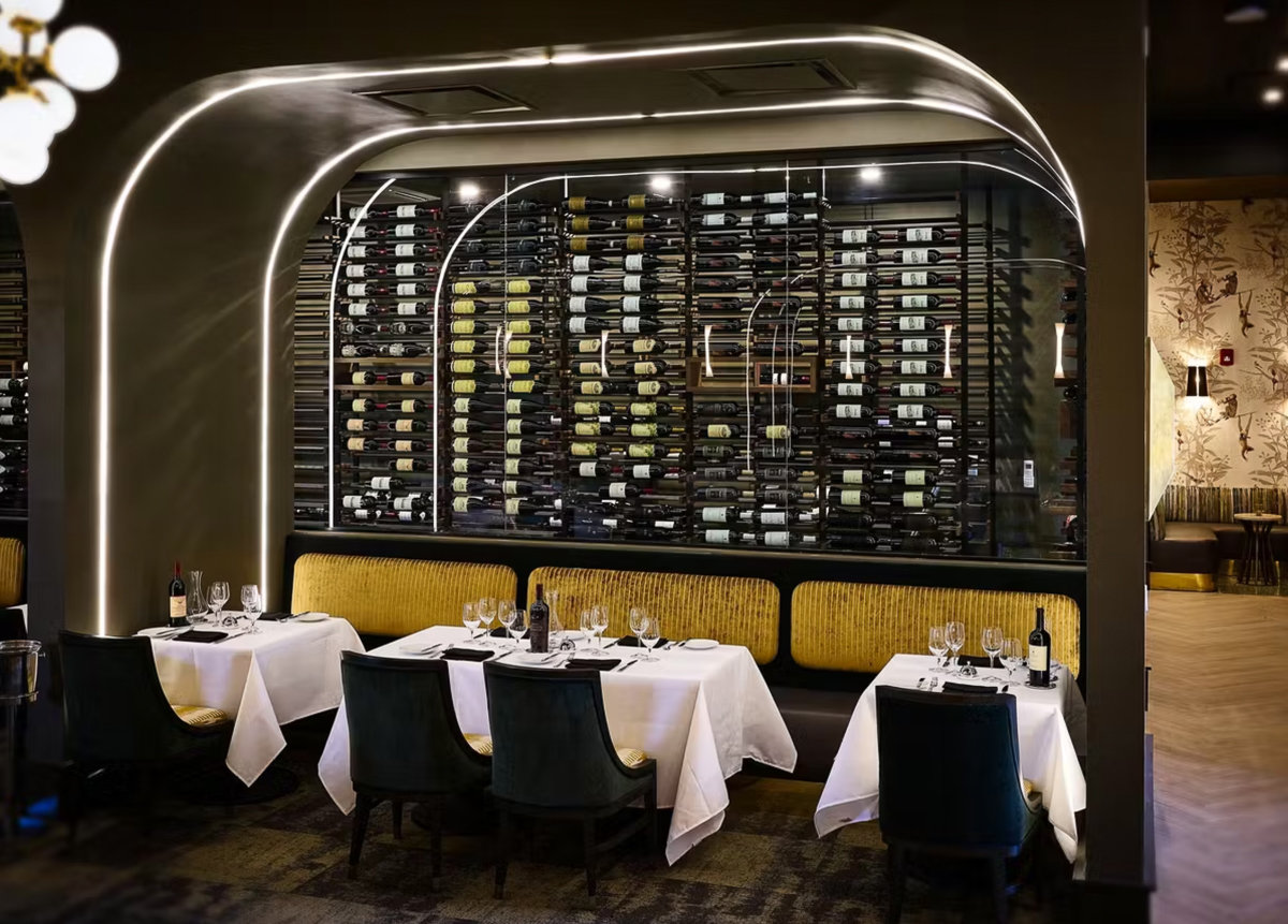 norman booths with wall of wine bottles